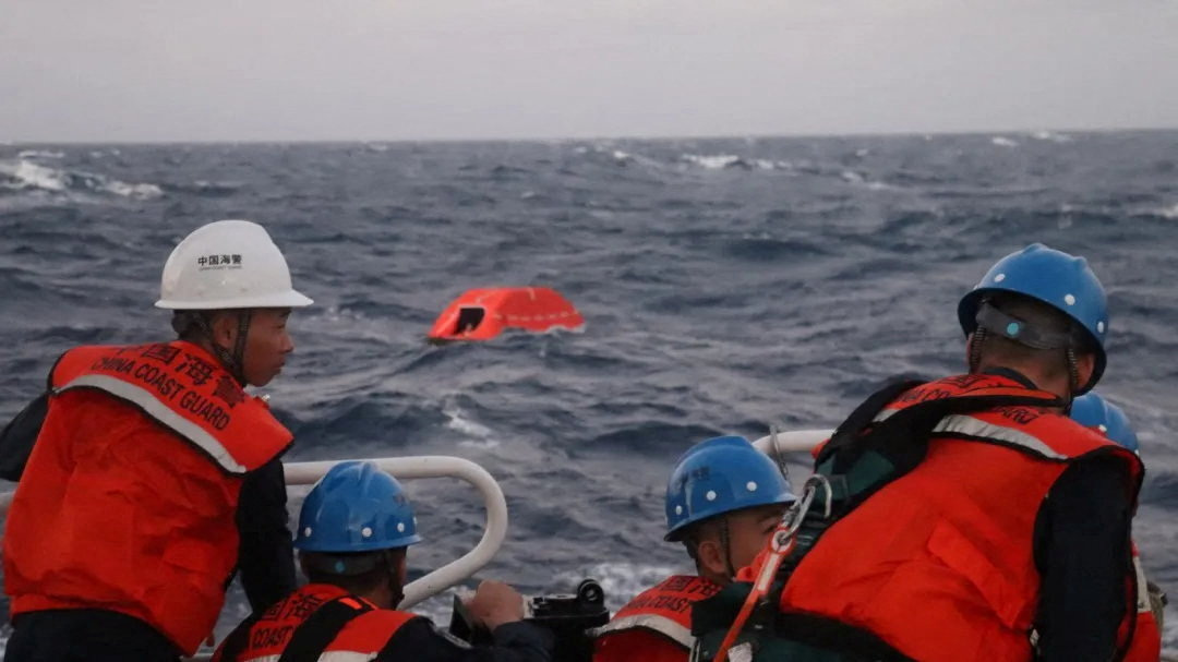 Above, Chinese coast guard personnel conduct rescue operations after receiving reports of a distressed cargo ship in the South China Sea on Jan. 23, 2026. (China Coast Guard via Reuters)