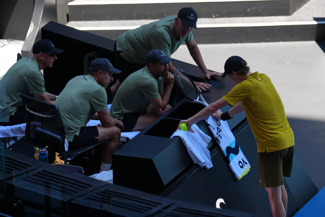 The third-round clash between defending champion Jannik Sinner, above, and the American Eliot Spizzirri at Rod Laver Arena was held up because of extreme heat. It resumed after about 10 minutes following the closure of the roof. (AP)