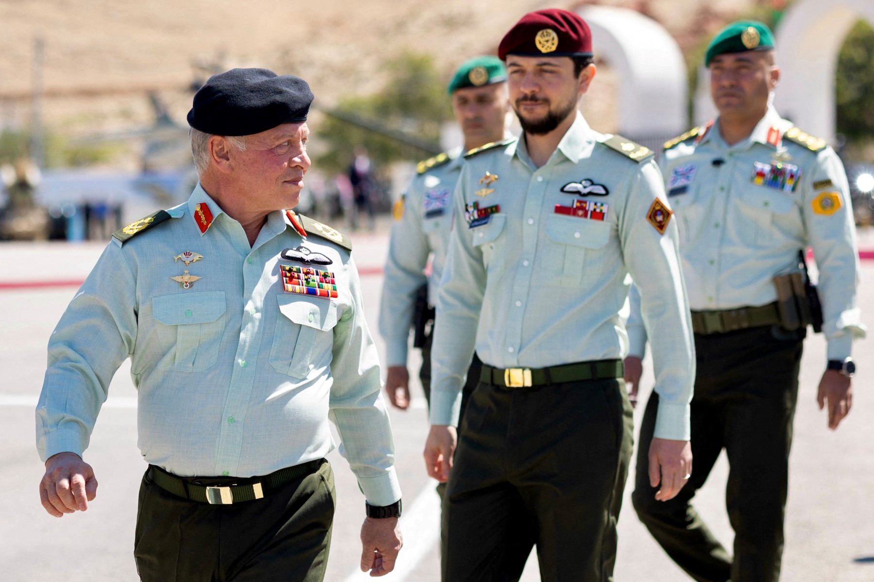 This handout picture released by the Jordanian Royal Palace shows Jordan's King Abdullah II (L) and his son Crown Prince Hussein (C) attending a ceremony marking the 57th anniversary of the Battle of al-Karamah during the War of Attrition with Israel, held by the Jordan Armed Forces-Arab Army at the Martyrs’ Memorial in al-Karamah in western Jordan on March 23, 2025. (AFP)