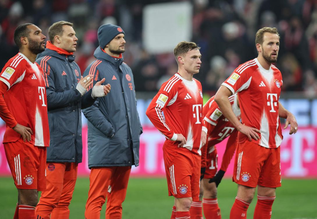 Bayern Munich’s defender Jonathan Tah, goalkeeper Manuel Neuer, midfielder Joshua Kimmich and forward Harry Kane look on after they were defeated by 1-2 against FC Augsburg in Munich, on Jan. 24, 2026. AFP)