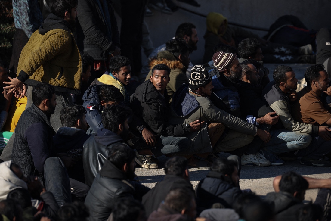 A photo dated December 2025 shows migrants waiting to be transfered at the port of Agia Galini after being rescued by Greek coast guard on the island of Crete, Greece. (AFP)