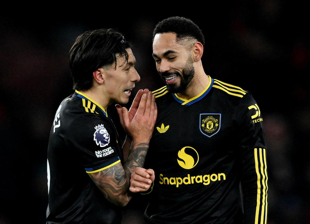 Manchester United’s Matheus Cunha celebrates after the match with Lisandro Martinez. (Reuters)