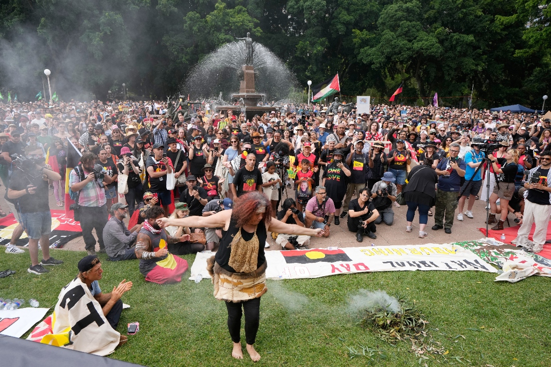 An Aboriginal woman dances at a traditional smoking ceremony during a "Invasion Day" rally and march on Australia Day in Sydney, Australia. (AP)