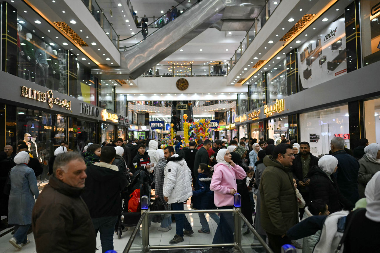 People shop at a shopping mall in the town of Al-Dana, near Sarmada, in the northern Syrian province of Idlib on December 13, 2024. (AFP)