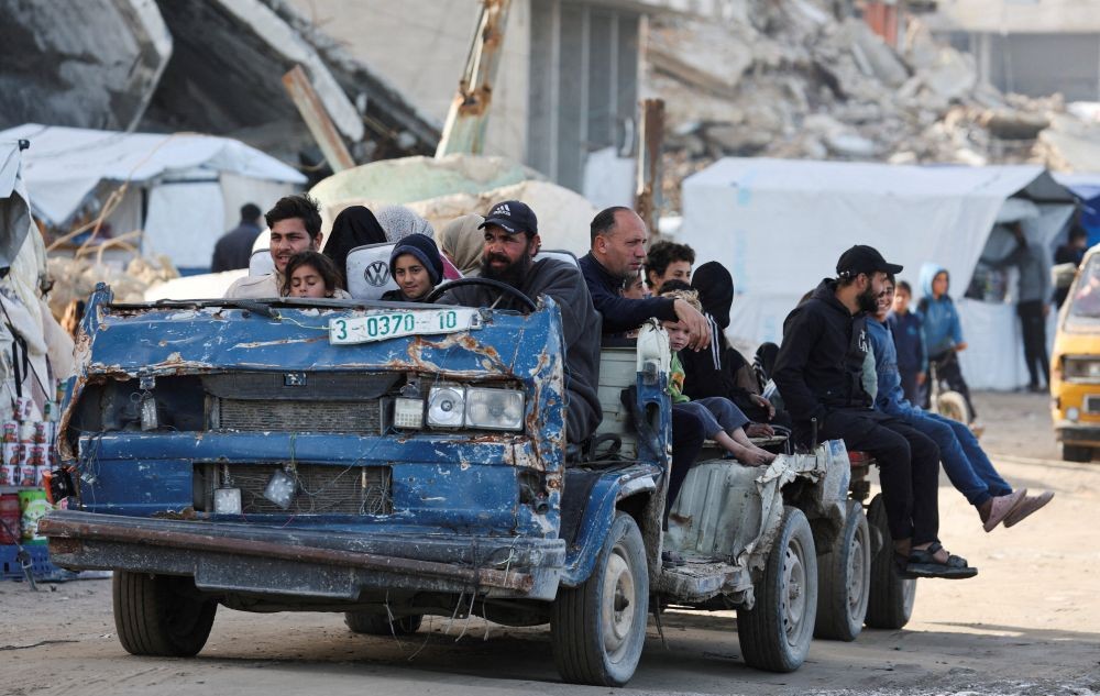 Hussein Liwa, a displaced Palestinian, transports residents in his war-damaged vehicle, Gaza City, Jan. 25, 2026. (Reuters)
