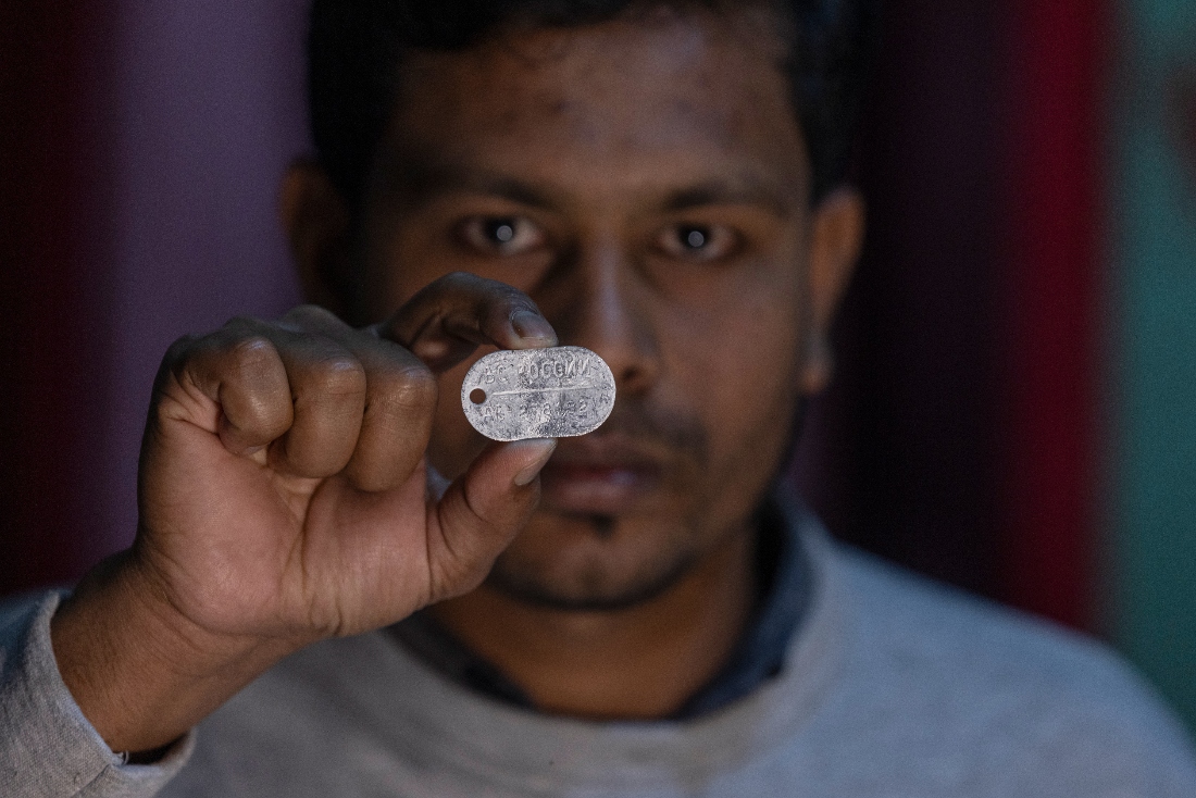 Maksudur Rahman, 31, who escaped after fighting for the Russian army, shows a Russian military dog tag during an interview in Lakshmipur, Bangladesh. (AP)
