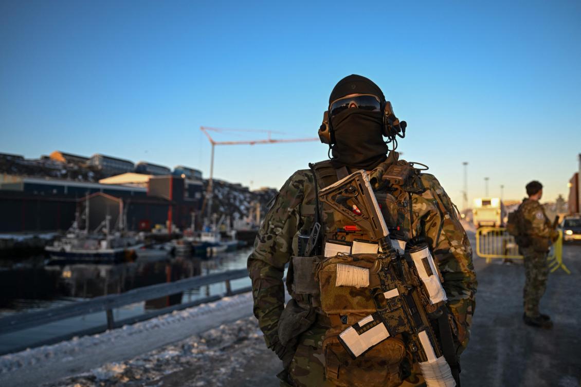 TOPSHOT - A Danish soldier stands at a checkpoint in the harbor of Nuuk, Greenland, on January 26, 2026. (AFP)