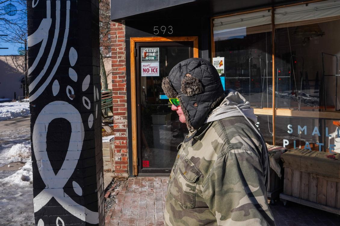 A man walks by a restaurant displaying an anti-ICE sign on January 24, 2026 in Portland, Maine. On Wednesday, The Department of Homeland Security launched "Operation Catch of the Day" targeting undocumented migrants in Maine. (Ryan Murphy/Getty Images/AFP)