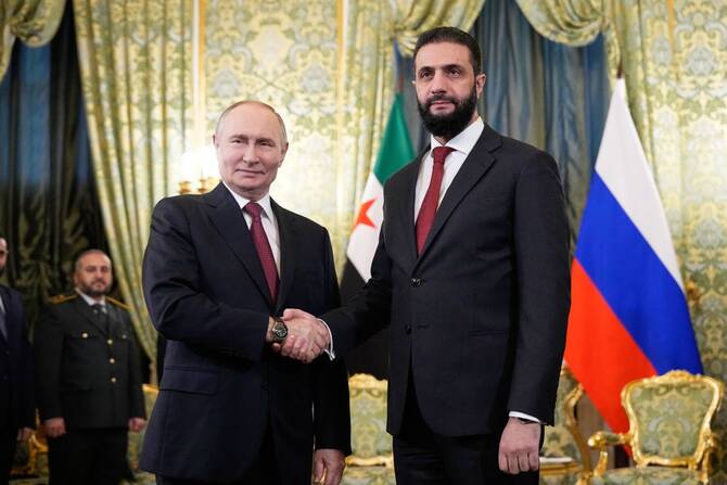 Russian President Vladimir Putin and Syrian President Ahmad Al-Sharaa shake hands during their first Kremlin meeting in October. (AFP/File)