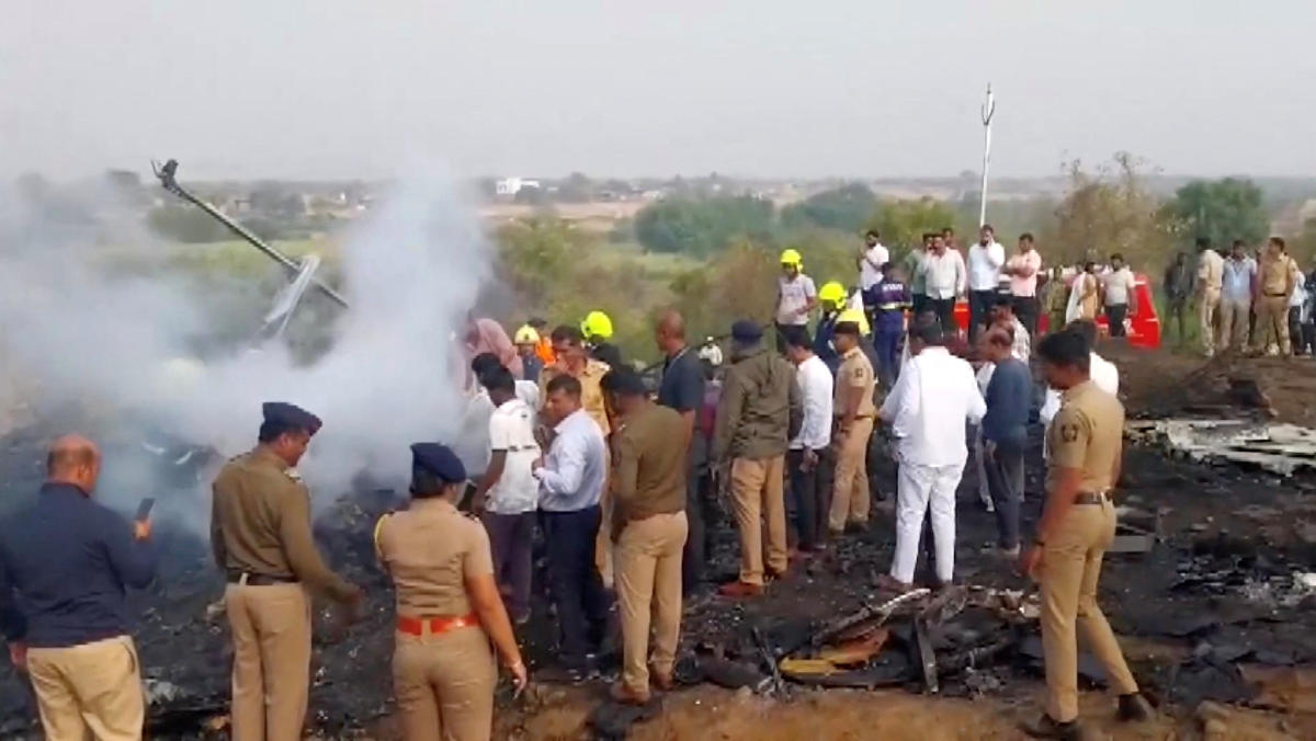 Emergency personnel and people gather at the site of a plane crash, in which Maharashtra's Deputy Chief Minister Ajit Pawar and four others were killed, in Baramati, Maharashtra, India January 28, 2026. (ANI/Handout via Reuters)