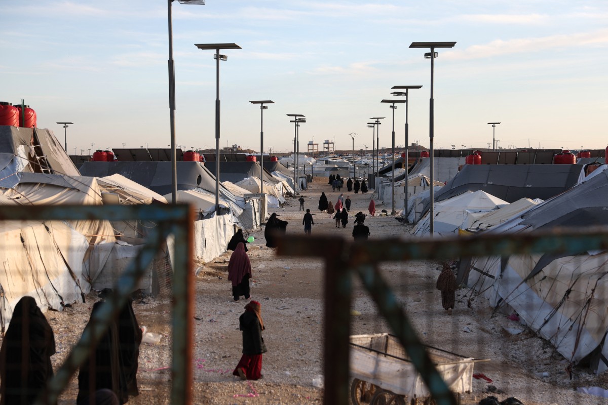 Children and women, relatives of suspected Islamic State jihadists, walk inside Al-Hol camp in the desert region of Syria's northeastern Hasakeh province on January 21, 2026. (File/AFP)