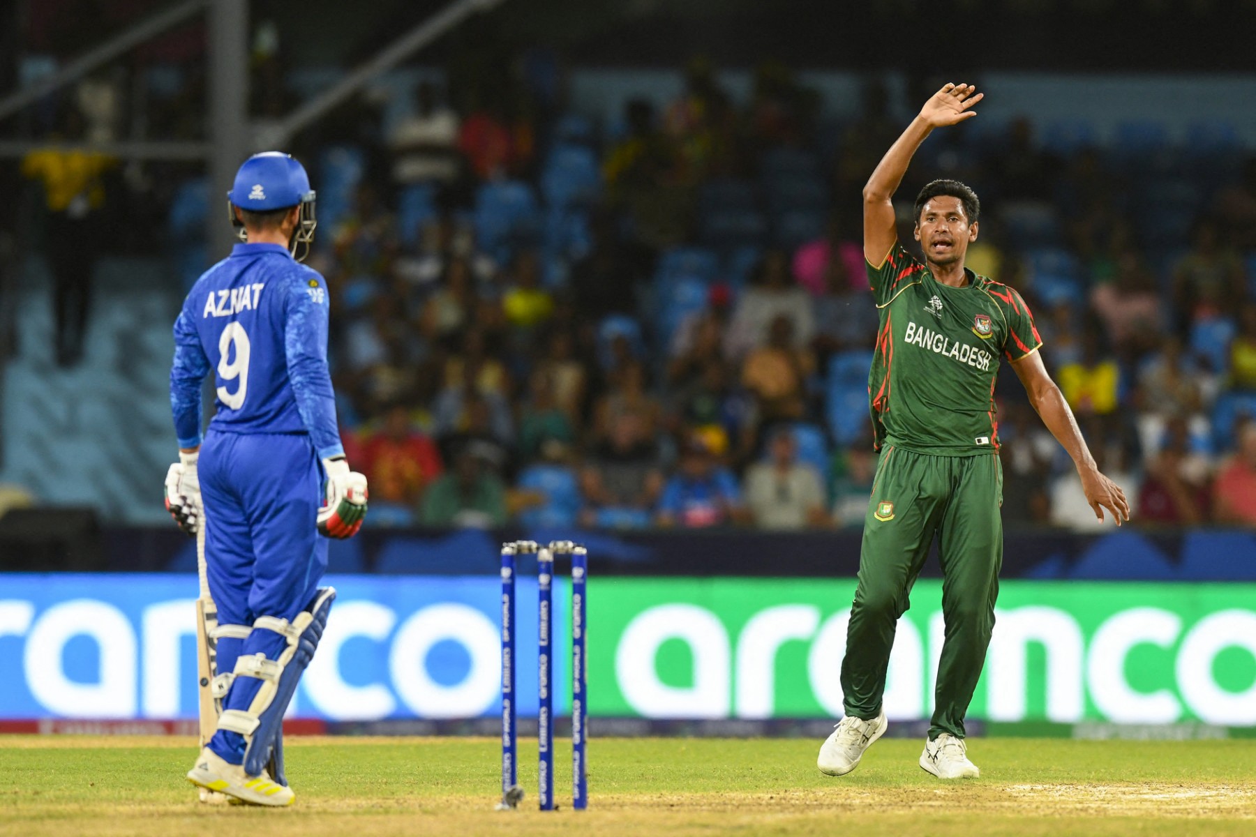 Bangladesh's Mustafizur Rahman (R) celebrates the dismissal of Afghanistan's Azmatullah Omarzai (L) during the ICC men's Twenty20 World Cup 2024. (File/AFP)