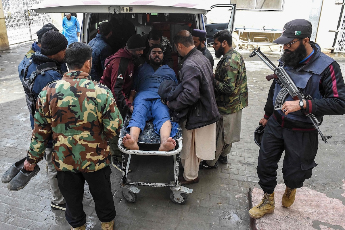 Security personnel transfer an injured man at a hospital in Quetta on Jan. 31, 2026, following an attack by Baloch separatists. (AFP)