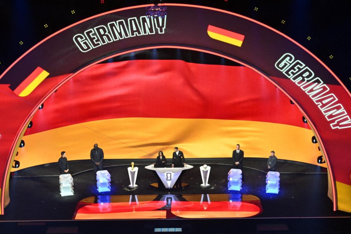 Germany's flag is displayed on a screen during the draw for the 2026 FIFA Football World Cup taking place in the US, Canada and Mexico, at the Kennedy Center, in Washington, DC, on December 5, 2025. (AFP)