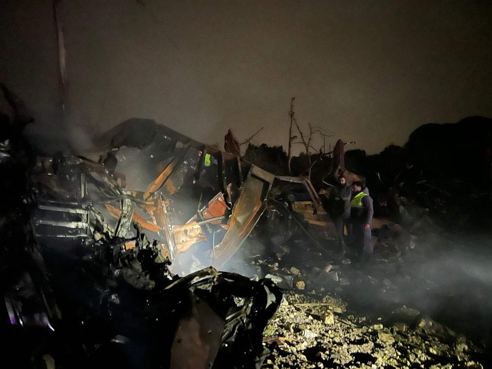 Firefighters look on after extinguishing a blaze caused by an Israeli airstrike that targeted a complex of large industrial machinery in the southern Lebanese village of Al-Marwanieh, on Jan. 30, 2026. (AFP)