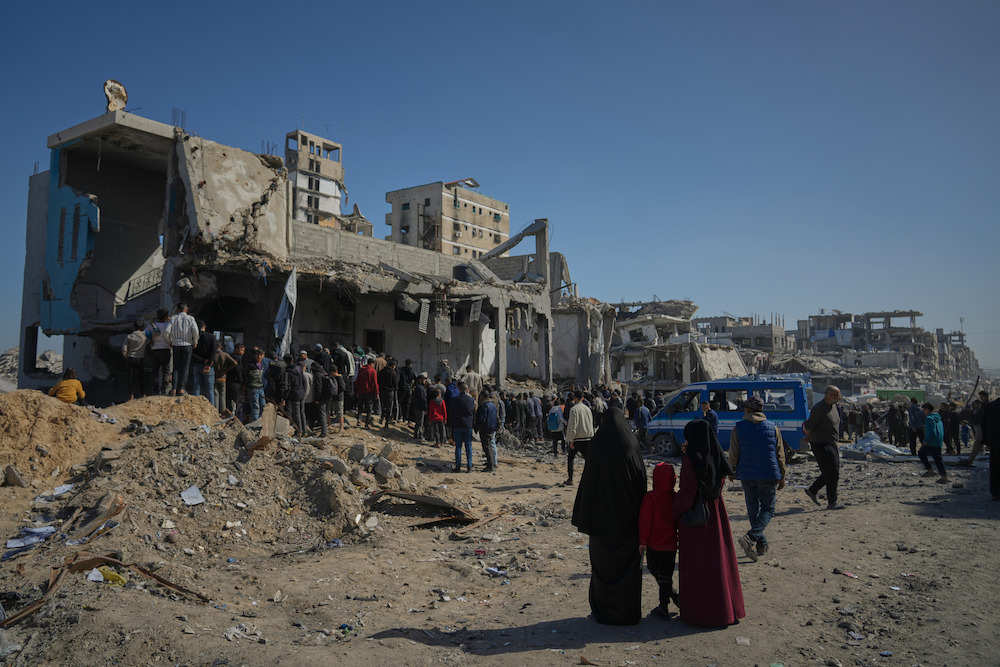 Palestinians search for bodies and survivors from the rubble of a police station after it was targeted by an Israeli army strike in Gaza City Saturday, Jan. 31, 2026. (AP)