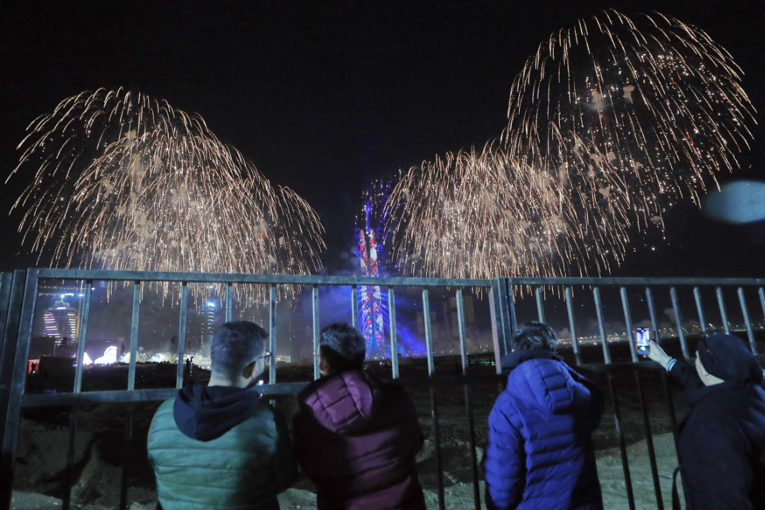 People watch fireworks over the Iconic Tower in Egypt's New Administrative Capital, just outside Cairo, Egypt. (AP)