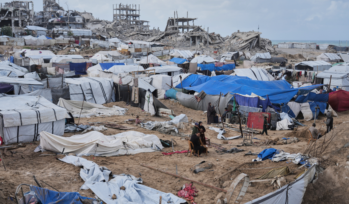 Palestinians inspect damaged tents at a displacement camp following an Israeli strike in Gaza City, Friday, Jan. 9, 2026. (AP)