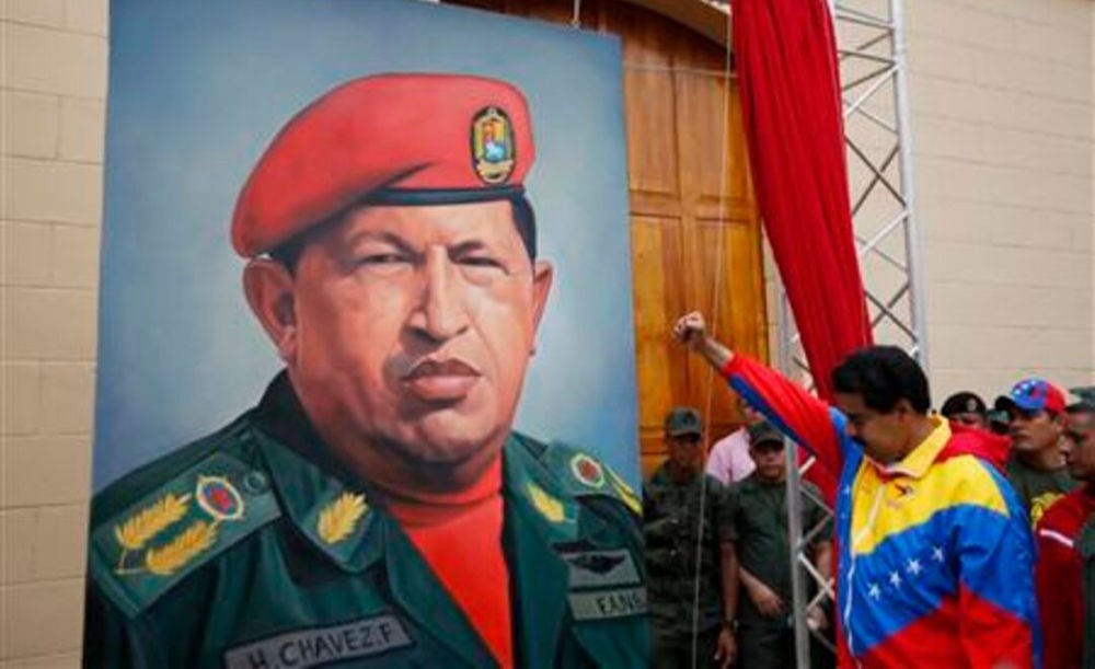 Nicolas Maduro salutes a portrait of Hugo Chavez in Caracas, Venezuela, Feb. 4, 2013. (Reuters)