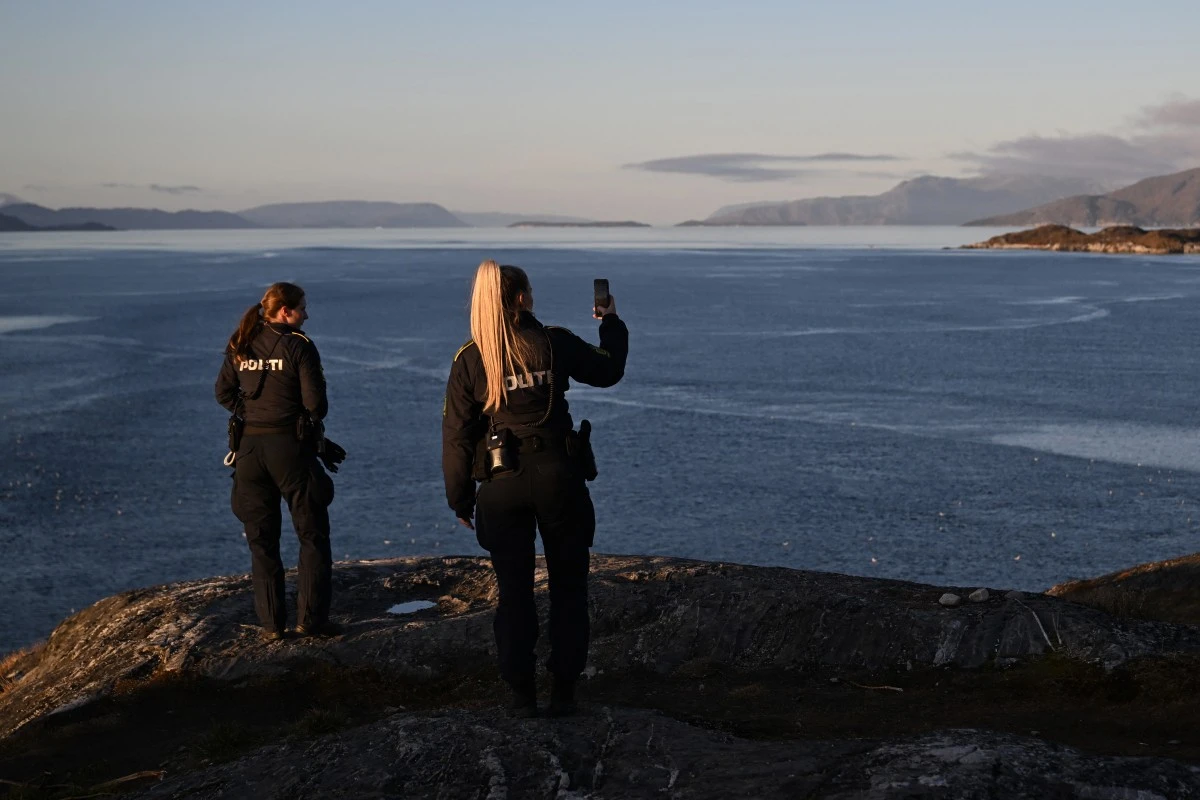 Two Danish police officers enjoy the view of Nuuk Fjord during sunset in Nuuk, Greenland, Sept. 23, 2025. (AFP)