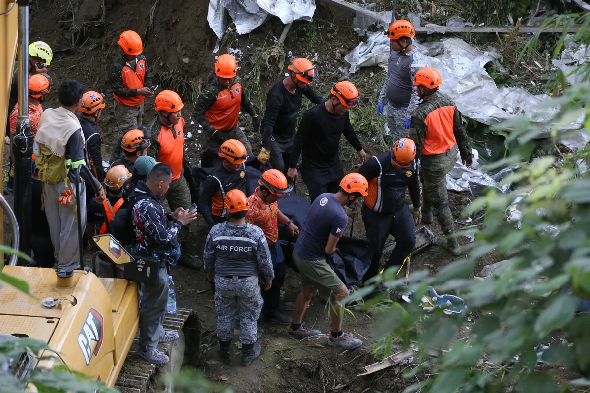 Philippine rescuers race to find dozens still trapped in deadly landfill collapse