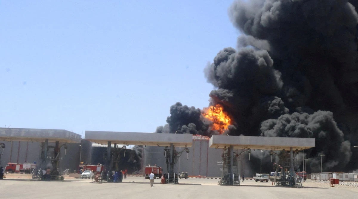 FILE PHOTO: A general view shows large plume of smoke and fire rising from fuel depot after what military sources told Reuters is a Rapid Support Forces (RSF) drone attack in Port Sudan targetting fuel storage facilities in Port Sudan, Sudan May 5, 2025. Sudan Ministry Of Energy And Petroleum/Handout via Reuters)