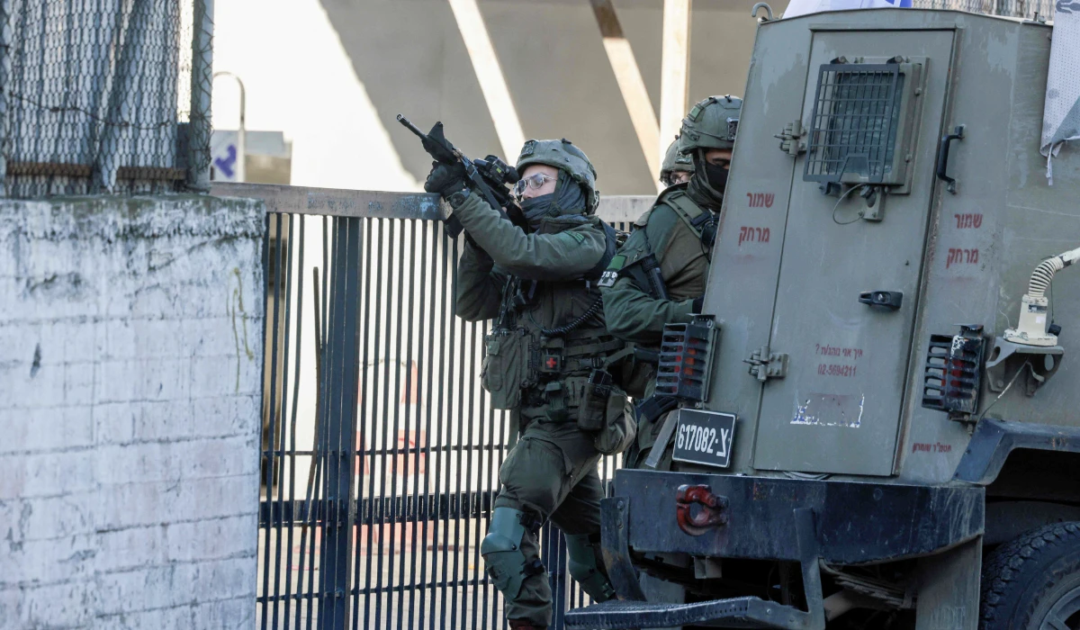 Israeli soldiers take positions during a military operation, around the old city of the Israeli-occupied northern West Bank city of Nablus on January 11, 2026. (AFP)