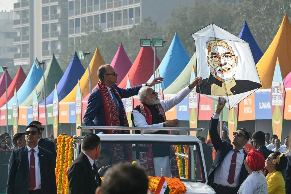 India’s Prime Minister Narendra Modi flies a kite with his portrait alongside German Chancellor Friedrich Merz during the International Kite Festival in Ahmedabad on Jan. 12, 2026. (AFP)