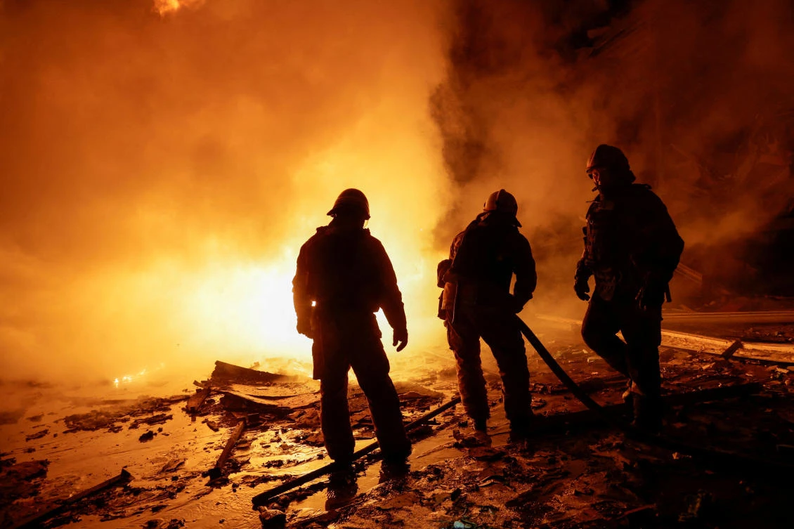 Firefighters work at the site of a logistics hub of a private delivery company hit by a Russian missile strike, amid Russia's attack on Ukraine, in Kharkiv, Ukraine January 13, 2026. (REUTERS)