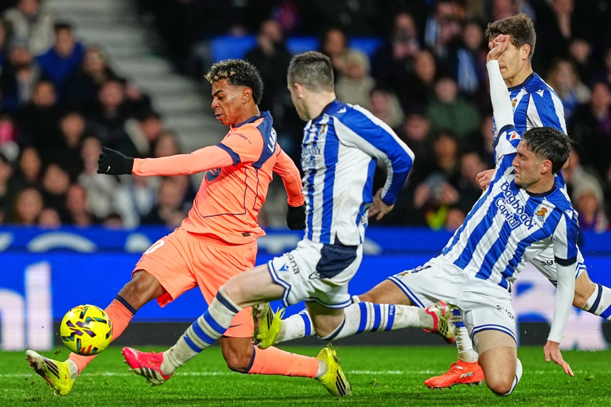 Barcelona's Lamine Yamal, left, in action during the Spanish La Liga soccer match between Real Sociedad and Barcelona in San Sebastian, Spain, Sunday, Jan. 18, 2026. (AP)
