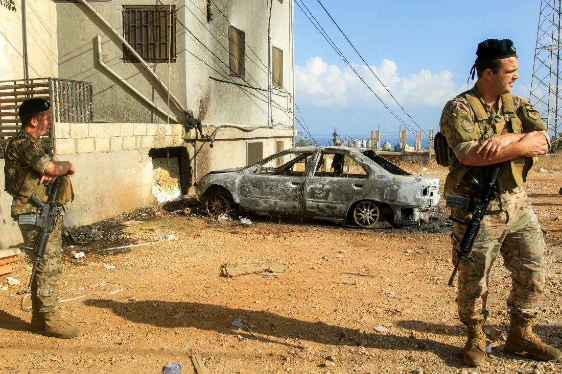 A photo dated September 2025 shows Lebanese army soldiers and security forces deploy near a vehicle that was hit by a reported drone-strike at the entrance of the village of Barja. (AFP)