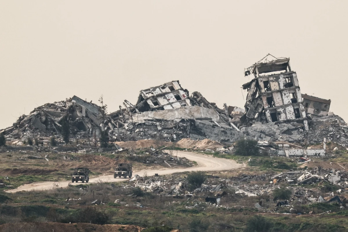 Israeli military vehicles drive past destruction in Gaza, as seen from the Israeli side of the Israel-Gaza border in southern Israel, January 21, 2026. (Reuters)