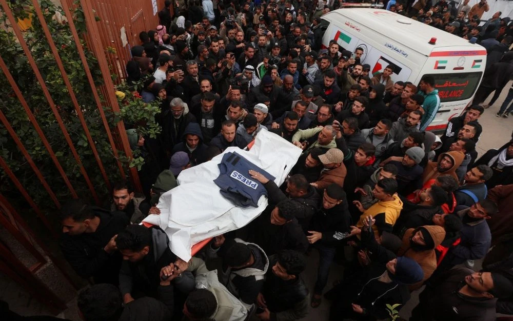 Mourners carry the body of one of the Palestinian journalists killed in an Israeli airstrike, Khan Younis, southern Gaza Strip, Jan. 21, 2026. (Reuters)