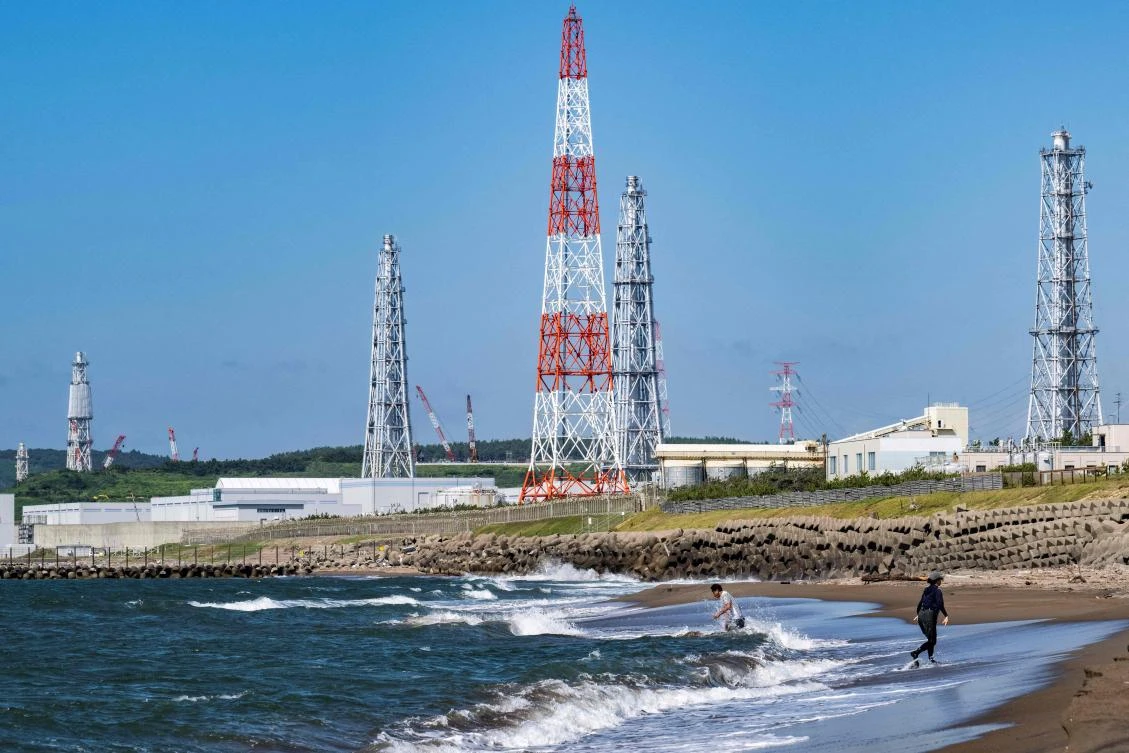 This picture taken on August 5, 2024 shows people visiting Arahama beach in front of the Kashiwazaki-Kariwa nuclear power station in Kashiwazaki, in Japan's Niigata prefecture. (AFP)