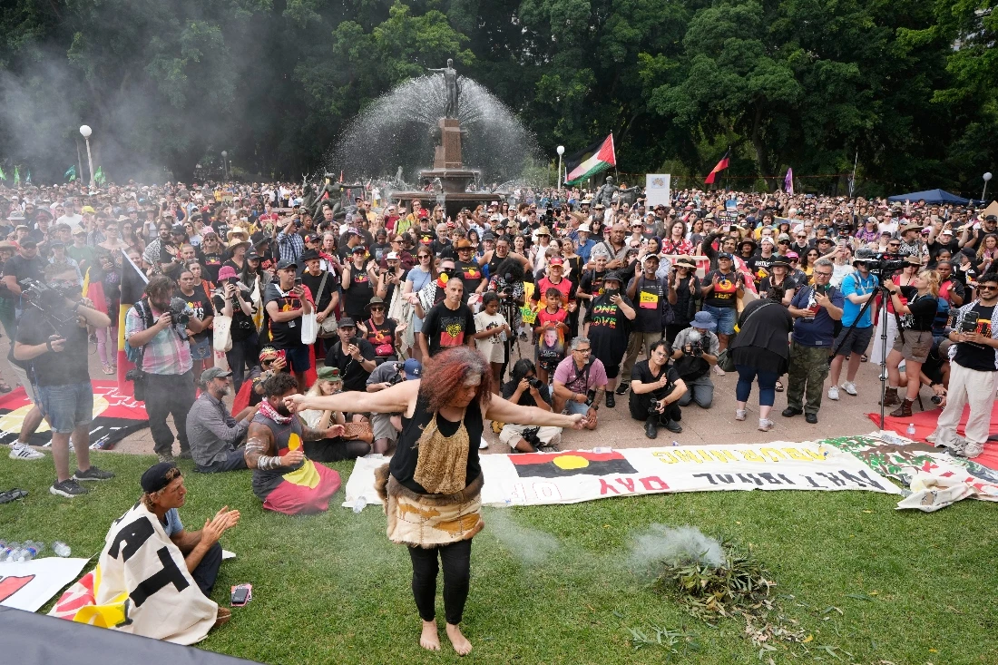 An Aboriginal woman dances at a traditional smoking ceremony during a "Invasion Day" rally and march on Australia Day in Sydney, Australia. (AP)