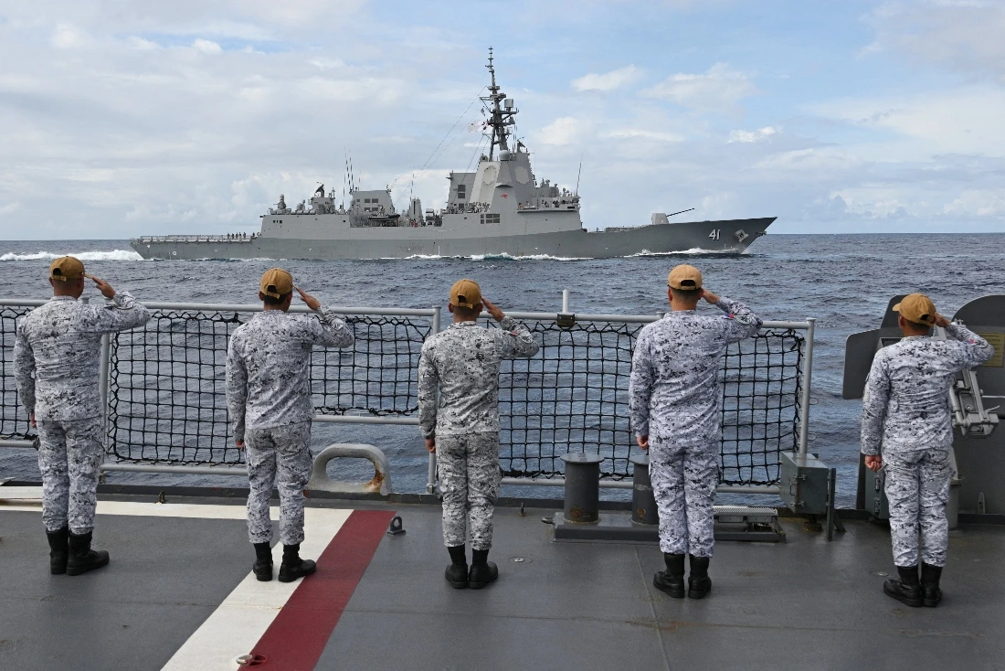 Sailors aboard the Philippine Navy frigate BRP Jose Rizal salute during near Scarborough Shoal in disputed waters of the South China Sea. (AFP) a passing exercise