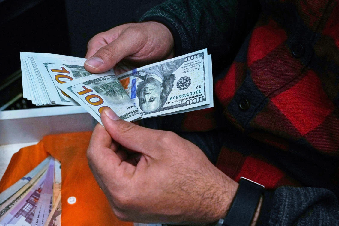 Iran’s currency drops to record low against dollar, tracking websites say