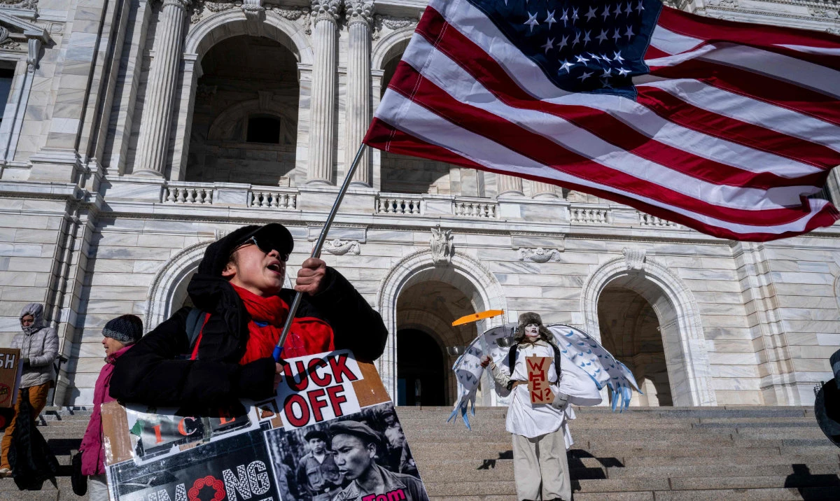Anti ICE protesters stand outside the Minnesota State Capitol Building after a small group of demonstrators gathered outside the office of the Minnesota Governor in Minneapolis, Minnesota, on January 27, 2026. (AFP)