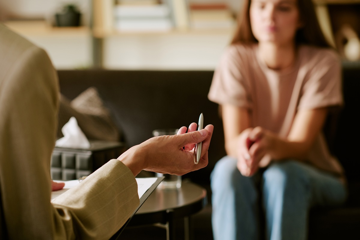 An illustrative image of a young woman engaging in a therapy session. (Shutterstock)