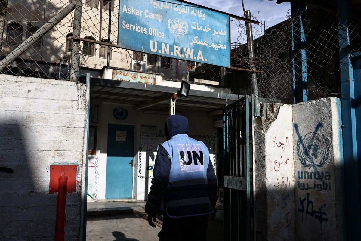 A man enters a building of UNRWA in the Askar camp for Palestinian refugees, east of Nablus in the Israeli-occupied West Bank, Dec. 31, 2025. (AFP)