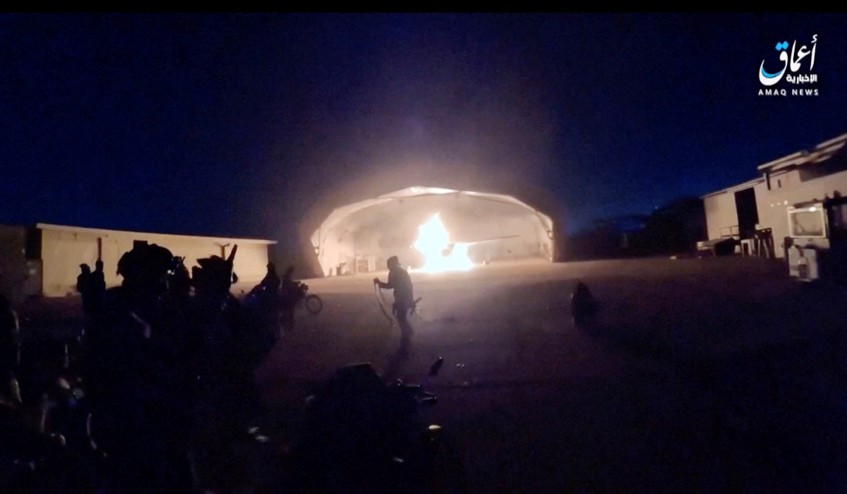 People run following an explosion as an aircraft burns in a hangar during an attack at the international airport in Niamey, Niger, January 28, 2026, in this still image obtained from a video. (REUTERS)