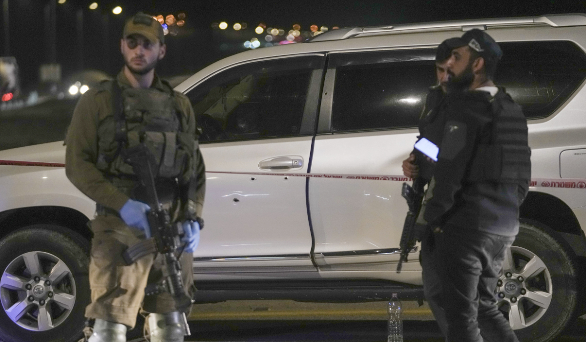 Israeli security forces examine the scene of a shooting attack near the West Bank city of Jericho, Monday, Feb. 27, 2023. (AP)