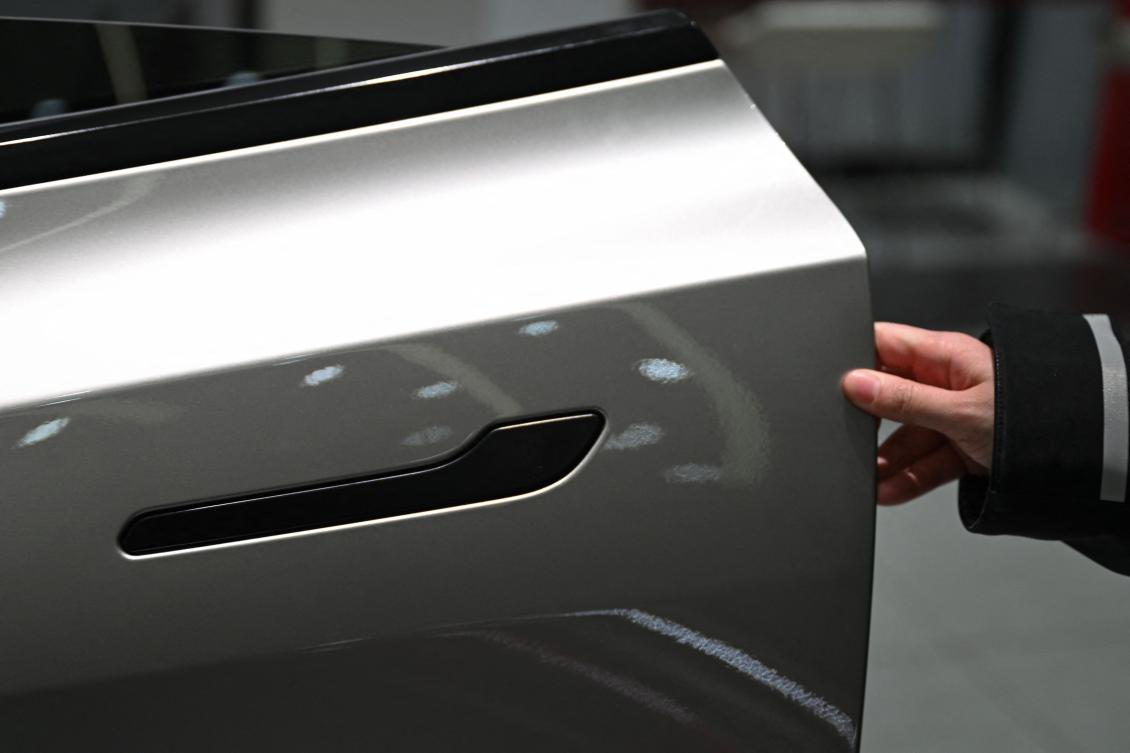 China will ban hidden door handles on cars sold in the country from next year, phasing out the minimalist design popularized by Tesla over safety concerns. (AFP)
