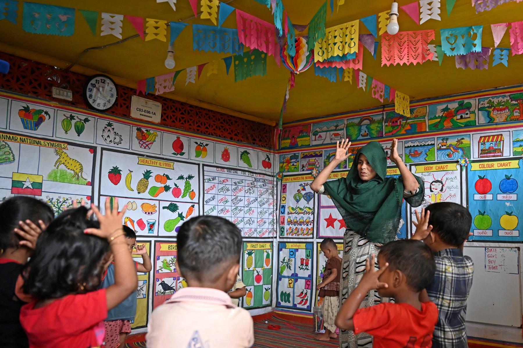 In this photo taken on September 12, 2024, a Rohingya woman teaches at a school in a refugee camp in Cox's Bazar, Bangladesh. (AFP/File)