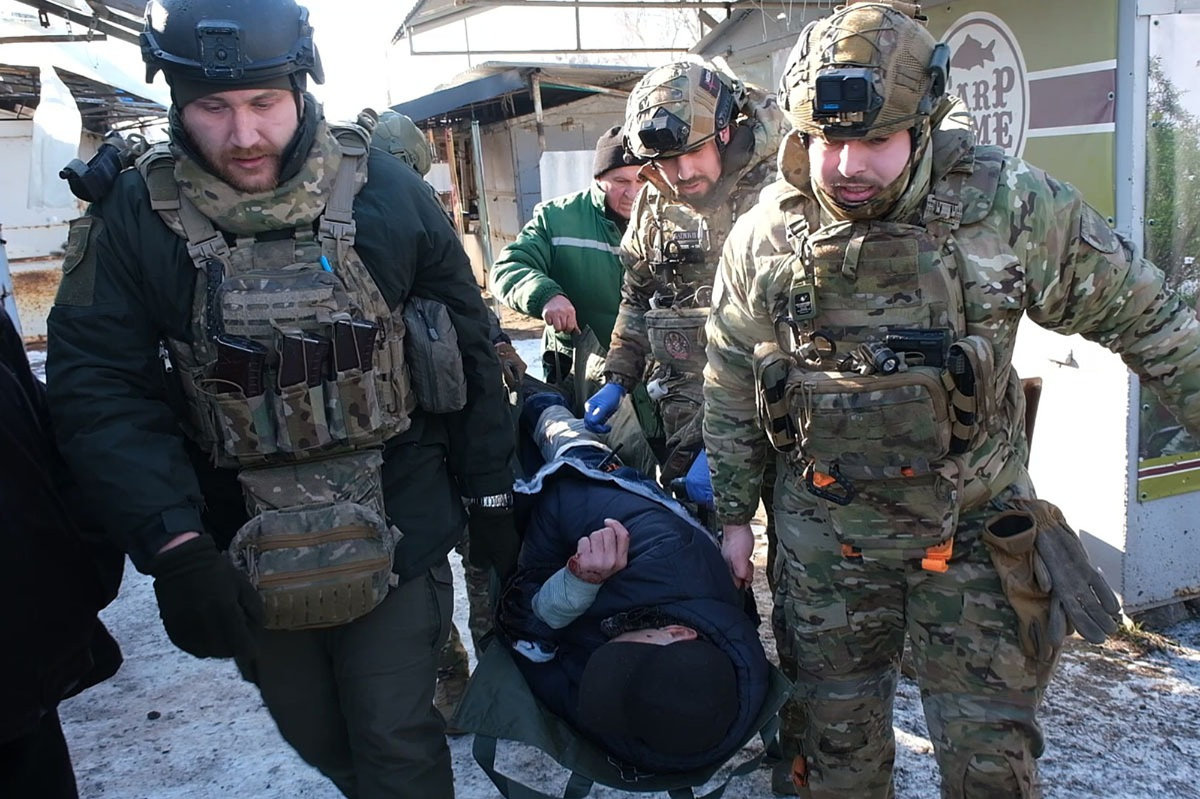 Ukrainian military paramedics carry a wounded civilian after a Russian shelling of the local market in the town of Druzhkivka, Donetsk region, on Feb. 4, 2026. (Ukrainian Police Press Service via AP)