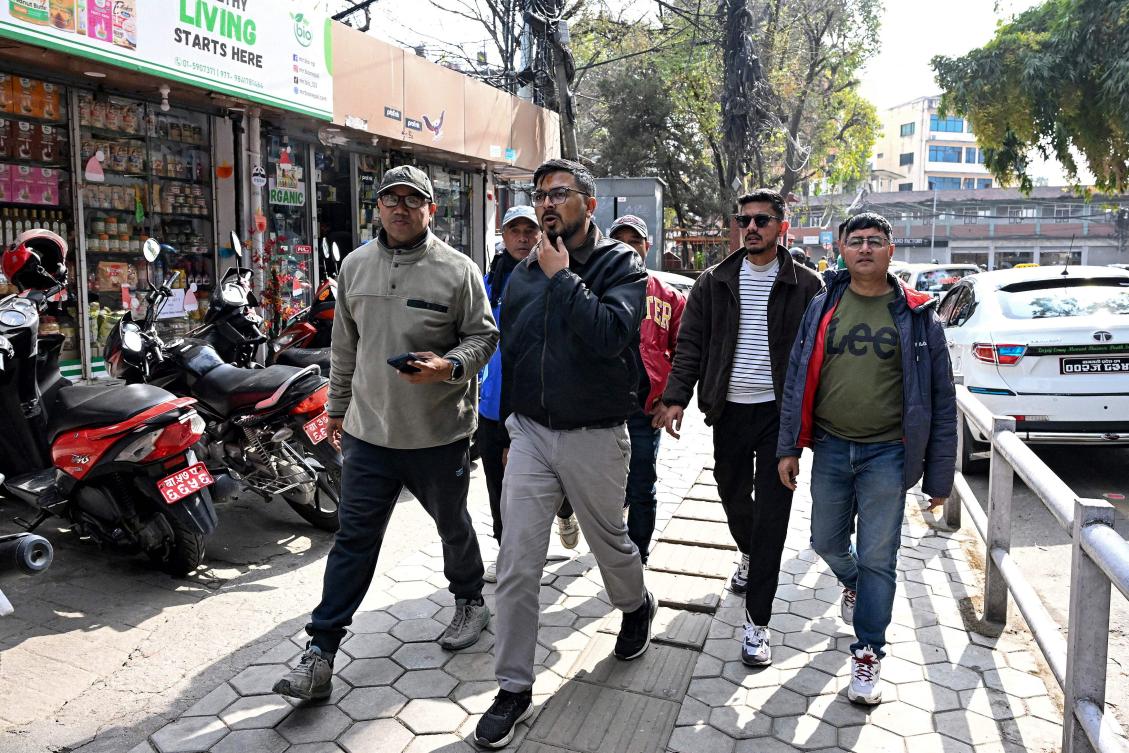 This photograph taken on February 3, 2026 shows Nepali Congress party election candidate Sachin Timalsena (C) walking along with his party workers across a market area in Kathmandu. (AFP)