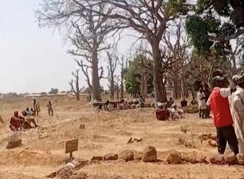 People stand around graves after a deadly attack by an armed gang in Katsina, Nigeria on Feb. 4, 2026, in this screengrab from video. (Reuters TV via Reuters)