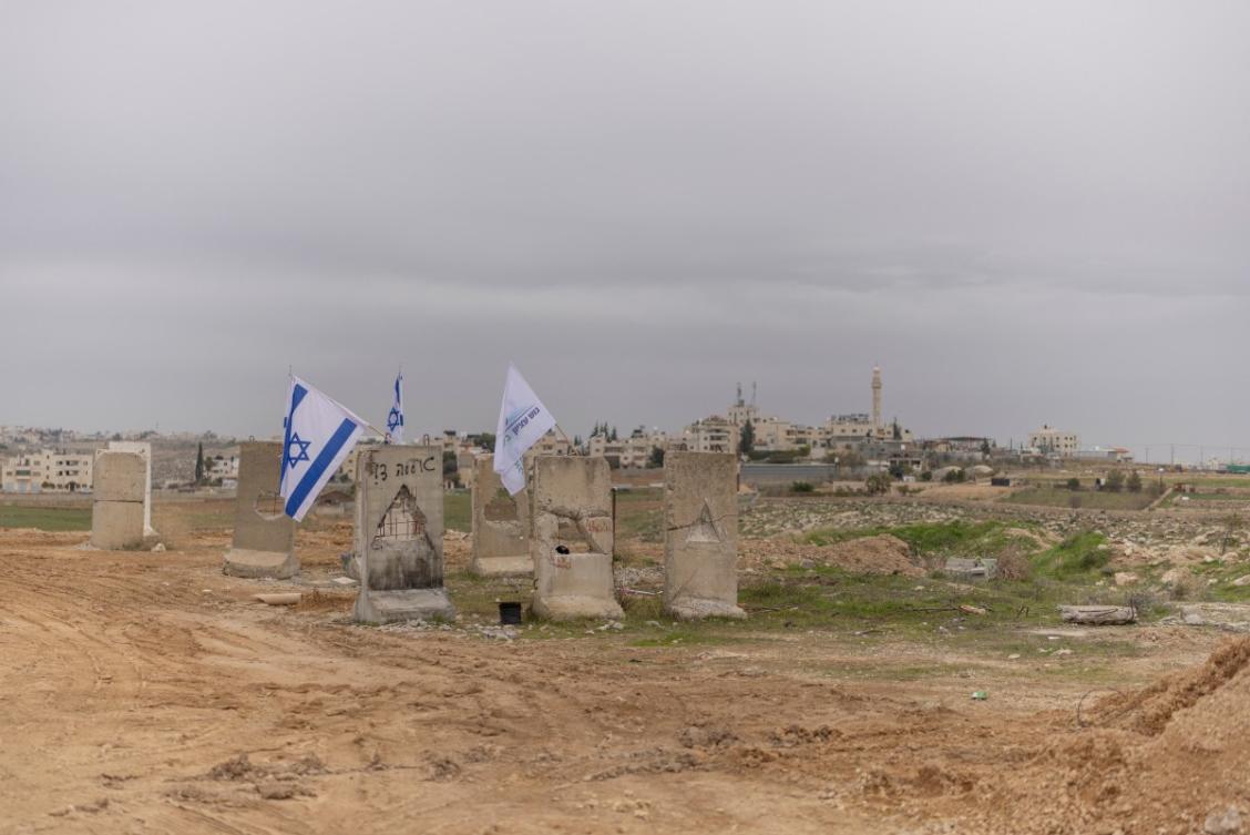 A photograph shows Israeli flags and a Gush Etzion council flag at the newly built Israeli settler outpost of “Yatziv” on the outskirts of the Palestinian town of Beit Sahur in the Israeli-occupied West Bank. (File/AFP)