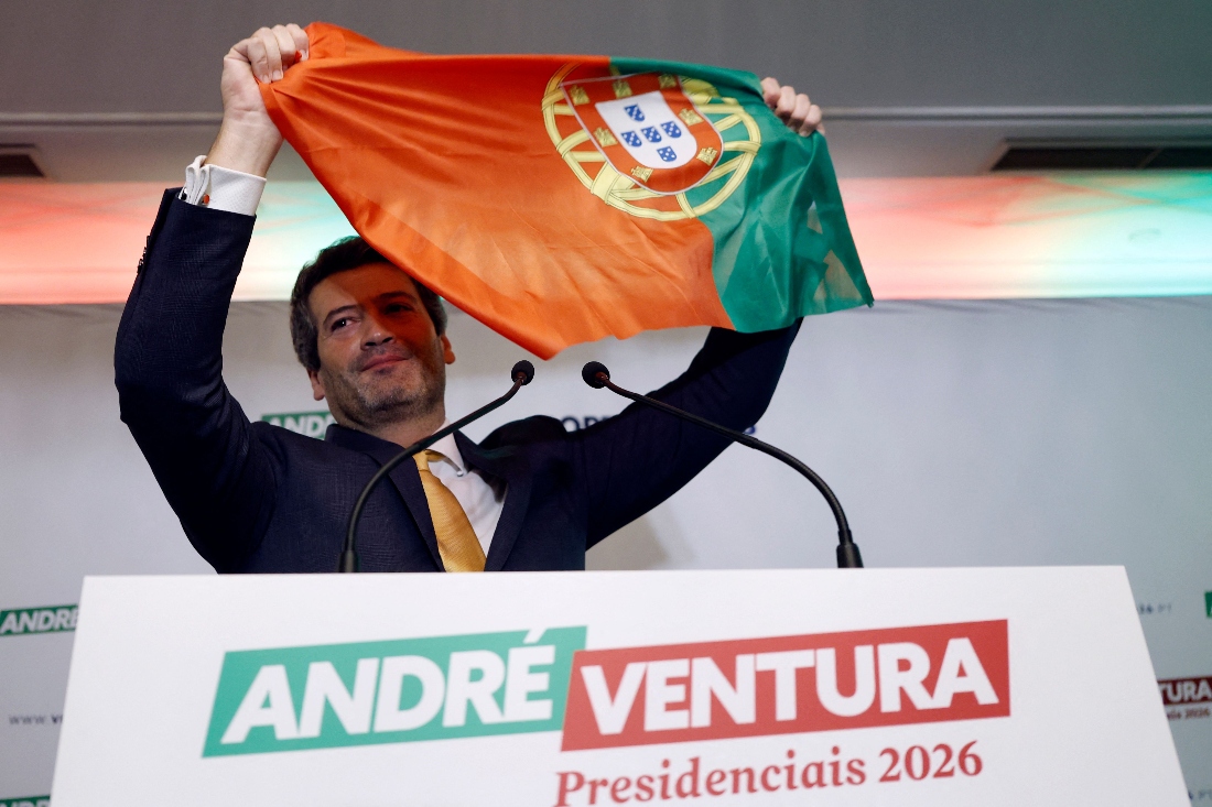 The leader of Chega (Enough) party, far-right candidate Andre Ventura waves a Portuguese flag as he addresses supporters on the night of Portugal's presidential election first round in Lisbon, Portugal. (AFP)