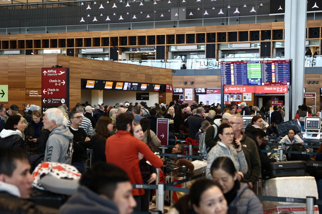 Passengers queue at Berlin Brandenburg Airport, which was closed due to severe ice on taxiways caused by freezing rain, in Berlin, Feb. 6, 2026. (Reuters)